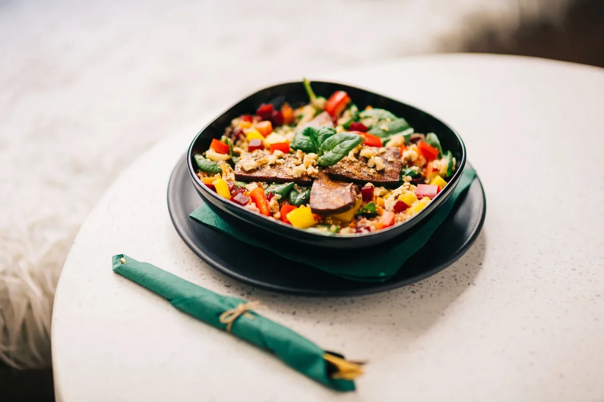 Assiette équilibrée avec portion de poulet, légumes variés et céréales complètes